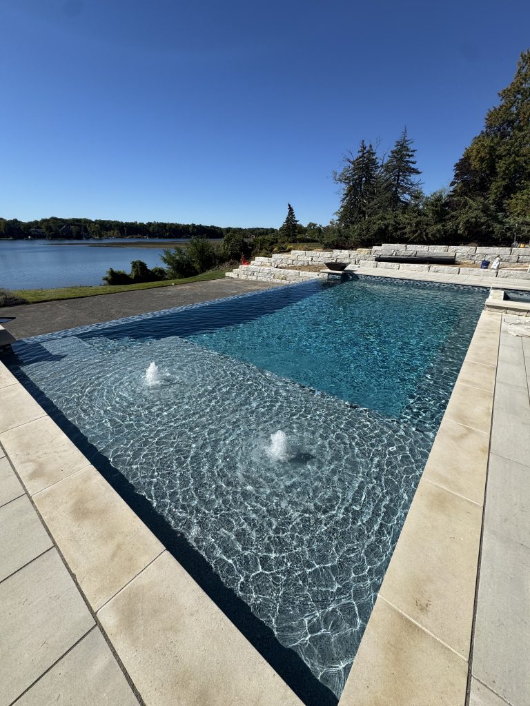 Resort style custom swimming pool in backyard